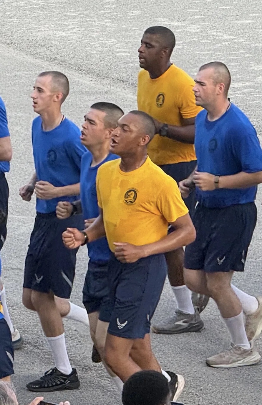Airmen in formation running during a training exercise