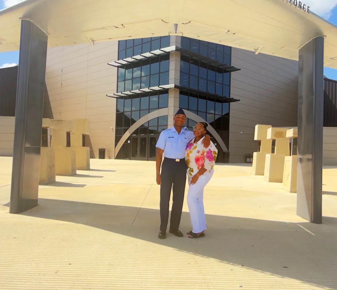 Patrice with her son in Air Force uniform outside the graduation building