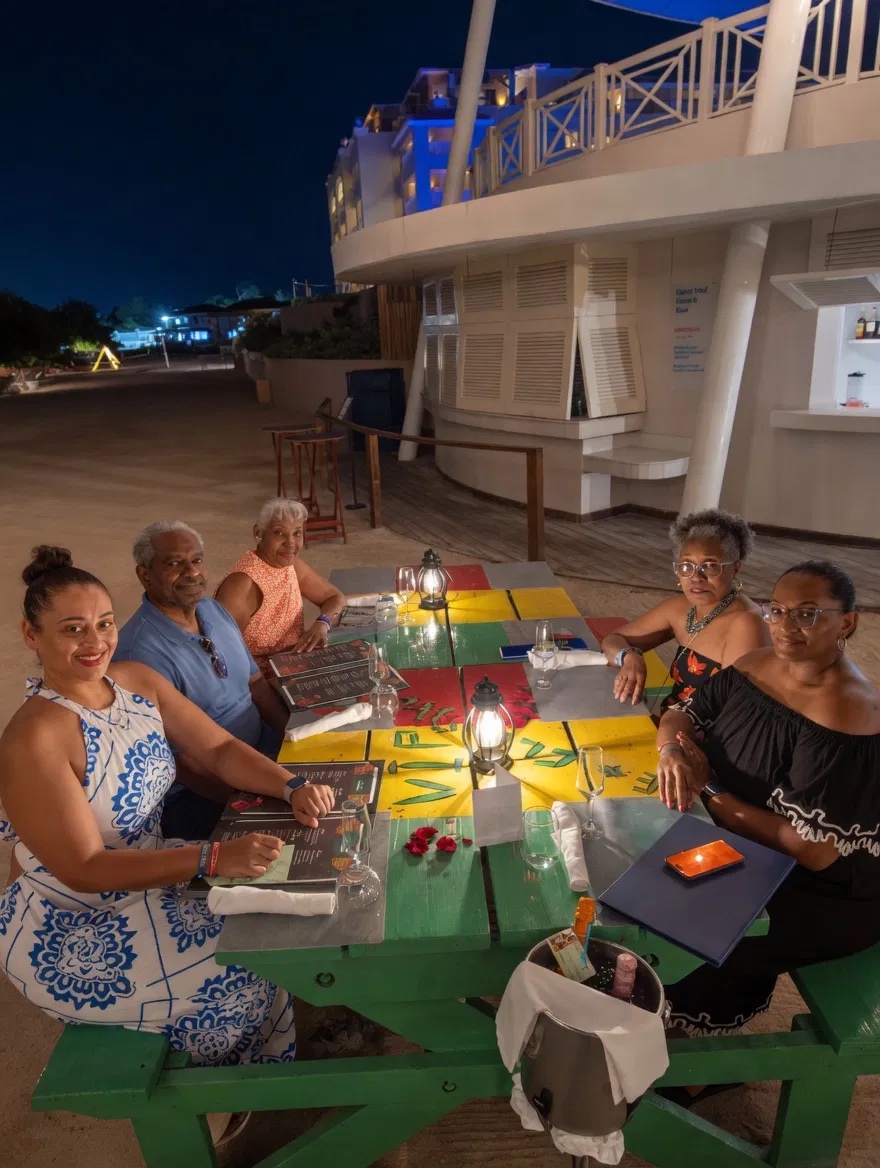 Evening dinner on the beach in Jamaica with lanterns lit at the table