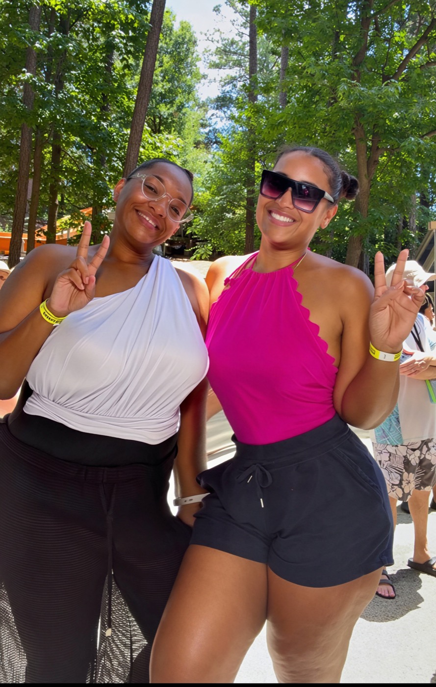 Patrice and her best friend making peace signs at a water park